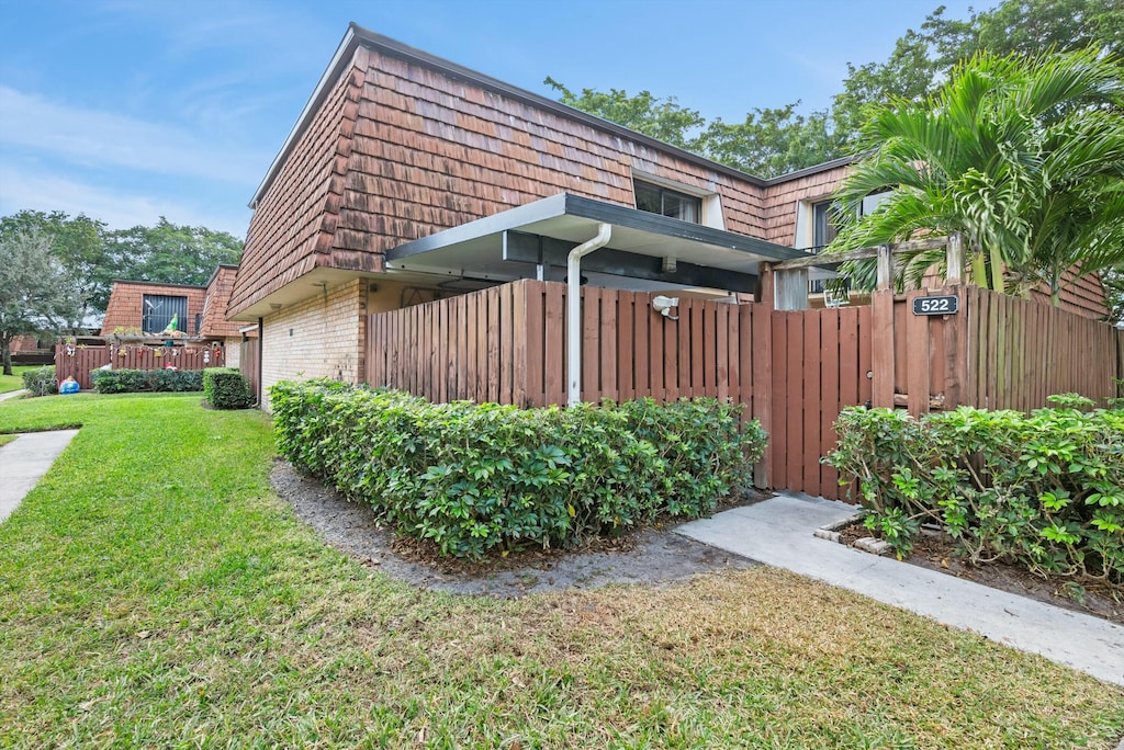 view of side of home featuring a yard