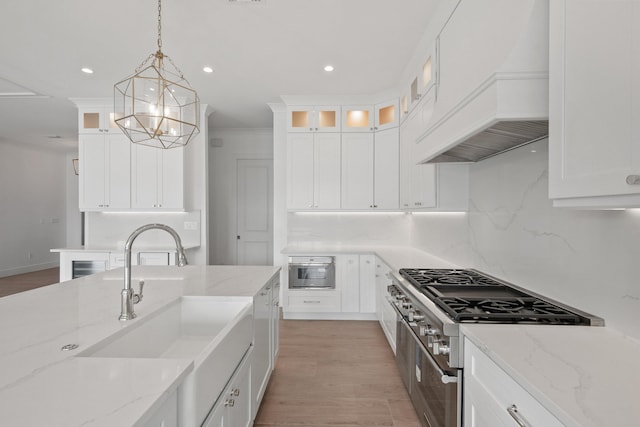 kitchen with pendant lighting, stainless steel appliances, and white cabinetry