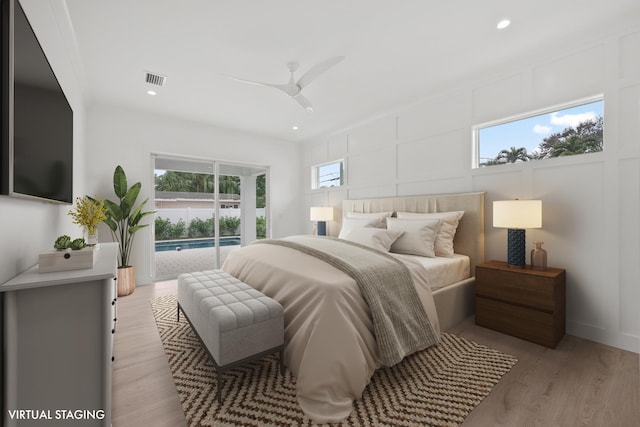 bedroom featuring access to outside, light hardwood / wood-style flooring, and ceiling fan