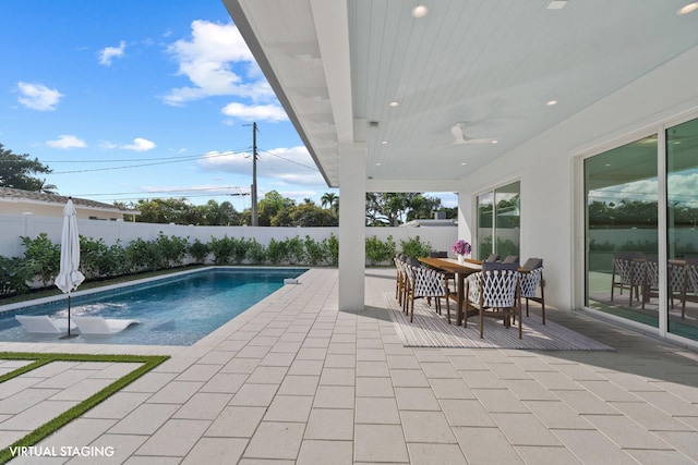 view of swimming pool with a patio area, a fenced backyard, outdoor dining area, and a fenced in pool