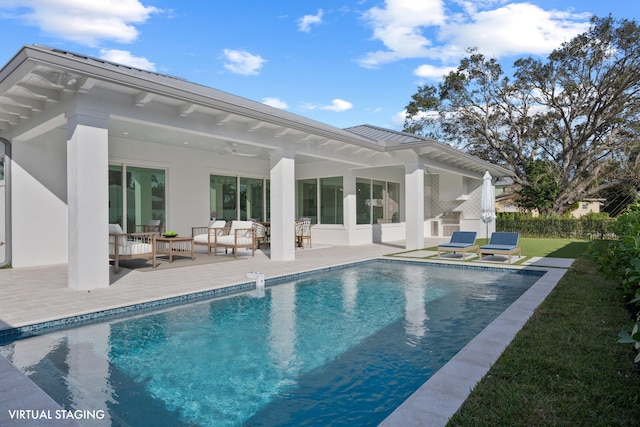 pool featuring an outdoor hangout area and a patio area