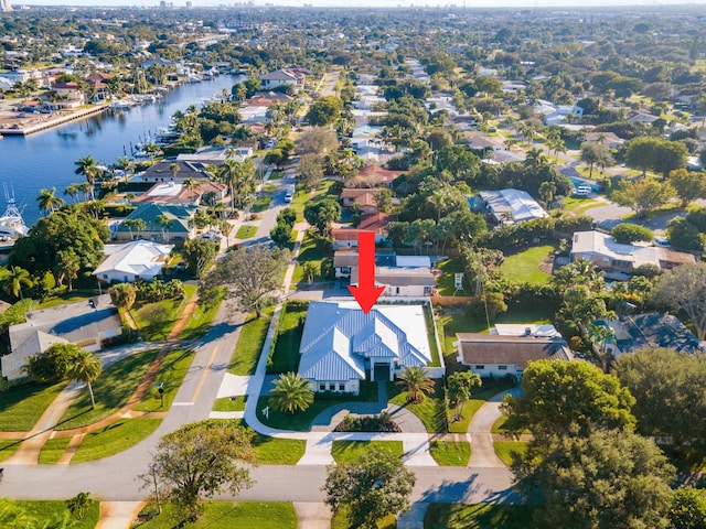 drone / aerial view with a water view and a residential view