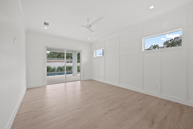 empty room featuring visible vents, a ceiling fan, light wood-style flooring, a decorative wall, and recessed lighting