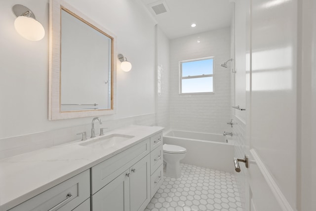 full bathroom featuring vanity, toilet, and tiled shower / bath