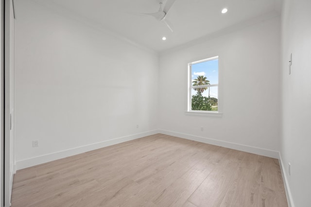 spare room featuring ceiling fan, recessed lighting, baseboards, light wood-type flooring, and crown molding