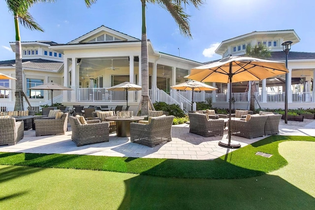 exterior space featuring a patio area, an outdoor hangout area, and a ceiling fan