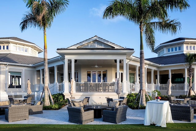 rear view of house featuring an outdoor living space with a fire pit, stucco siding, a ceiling fan, a patio area, and stairs