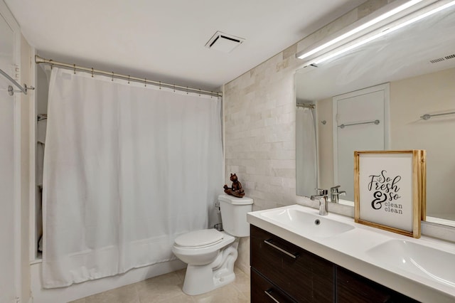 full bathroom with shower / tub combo, tile patterned floors, vanity, tile walls, and toilet