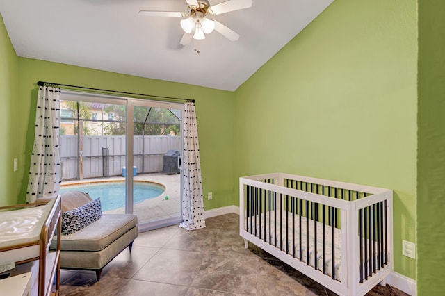 bedroom featuring a crib, vaulted ceiling, and ceiling fan