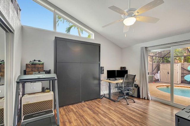 home office with lofted ceiling, a healthy amount of sunlight, wood-type flooring, and ceiling fan