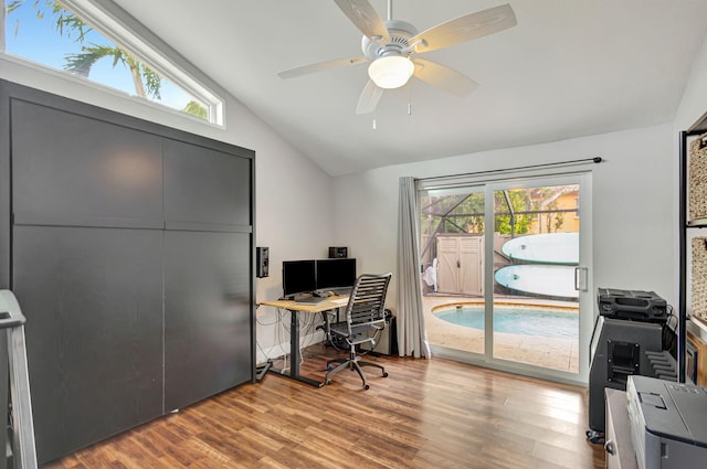 office featuring hardwood / wood-style floors, ceiling fan, a healthy amount of sunlight, and vaulted ceiling