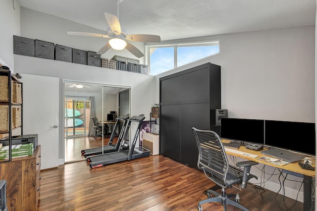 home office with ceiling fan, wood-type flooring, and vaulted ceiling