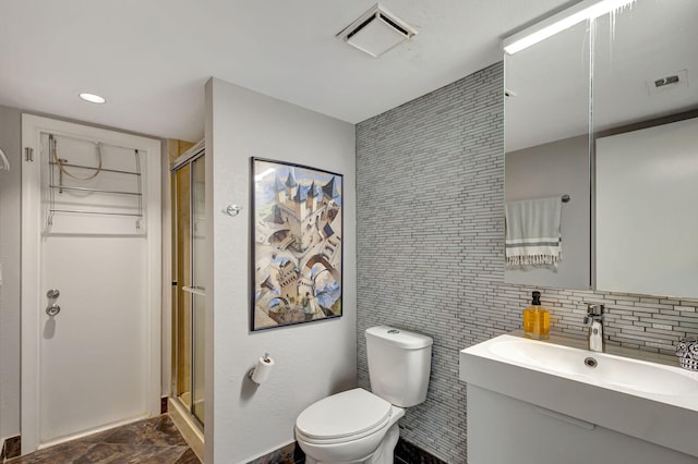 bathroom featuring vanity, a shower with shower door, tile walls, and toilet