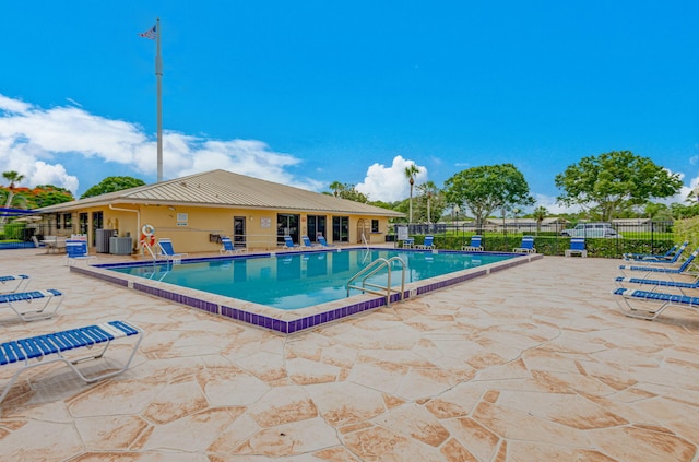 view of swimming pool featuring a patio and central AC