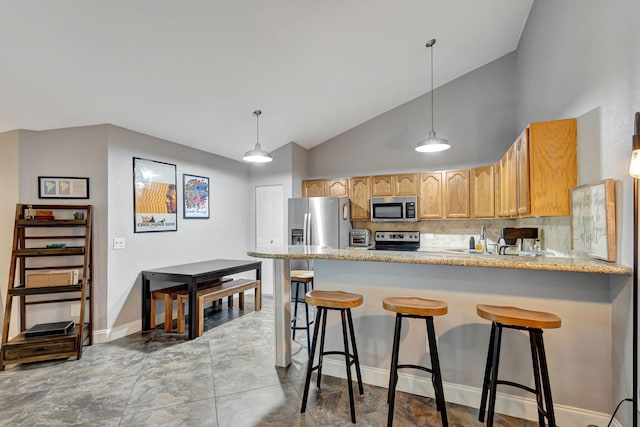 kitchen with kitchen peninsula, backsplash, stainless steel appliances, sink, and light brown cabinets