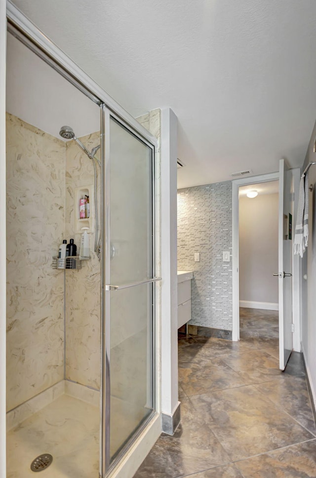 bathroom with vanity and a shower with shower door