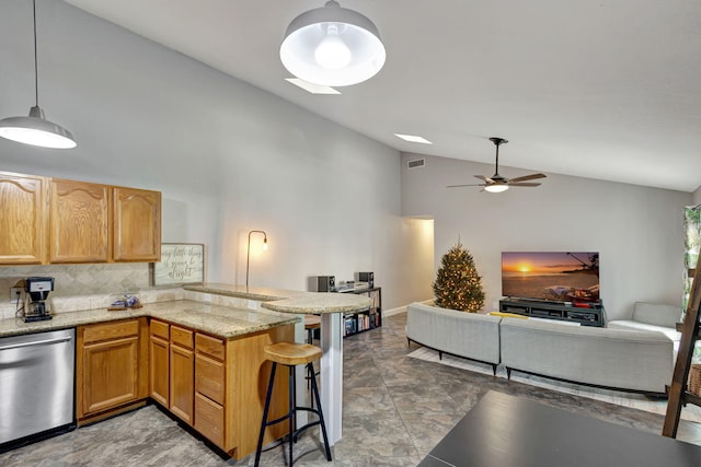 kitchen with kitchen peninsula, a kitchen breakfast bar, high vaulted ceiling, dishwasher, and hanging light fixtures