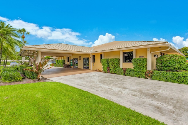 view of front facade with a carport and a front lawn