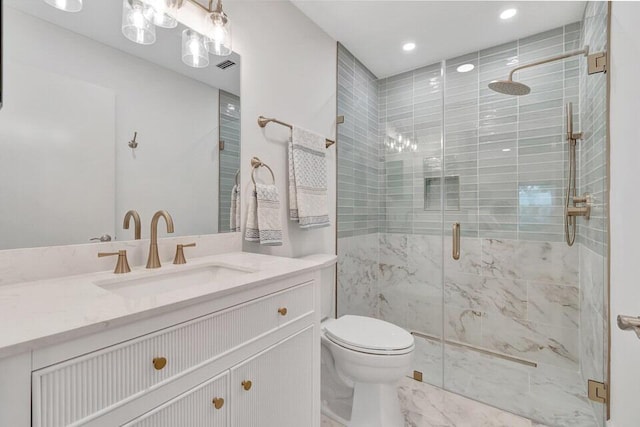 bathroom with vanity, toilet, and walk in shower