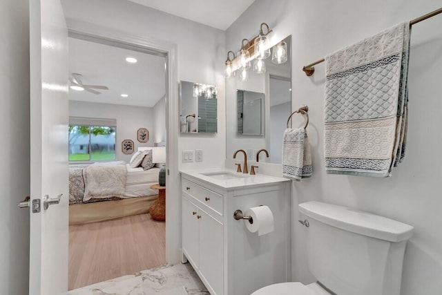 bathroom featuring ceiling fan, toilet, and vanity