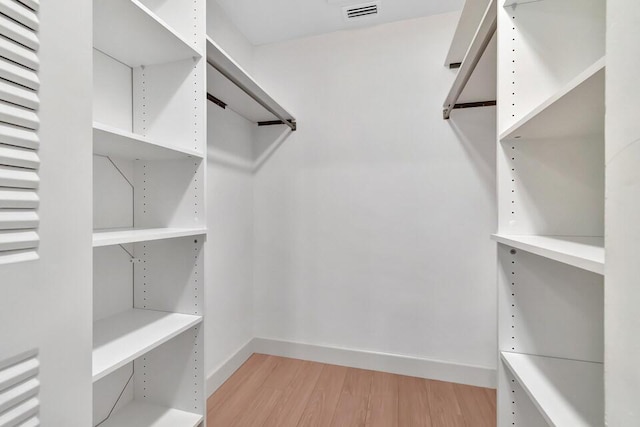 spacious closet with light hardwood / wood-style floors