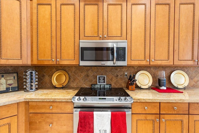 kitchen with decorative backsplash and appliances with stainless steel finishes