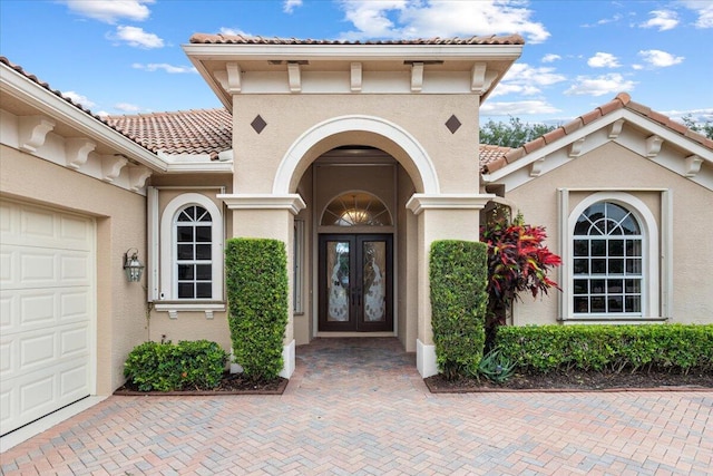 doorway to property with a garage