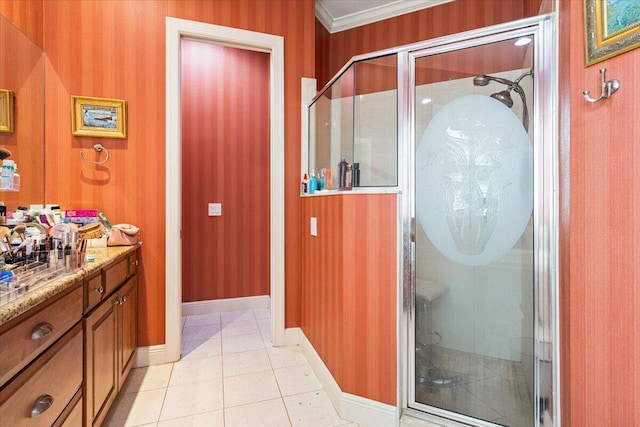 bathroom with tile patterned flooring, vanity, a shower with shower door, and ornamental molding