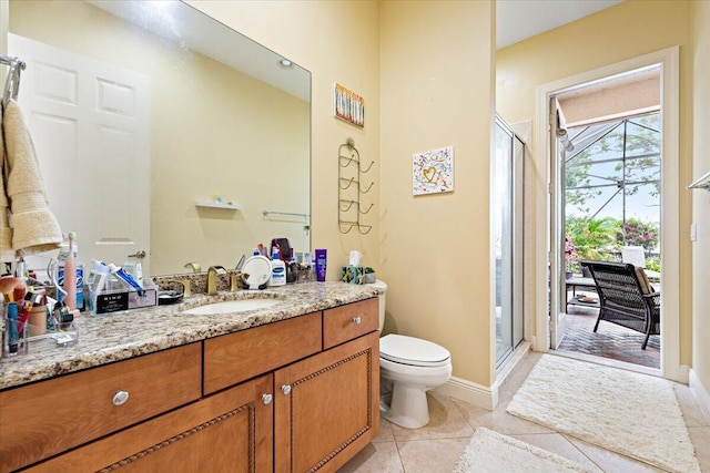 bathroom with tile patterned floors, toilet, vanity, and walk in shower