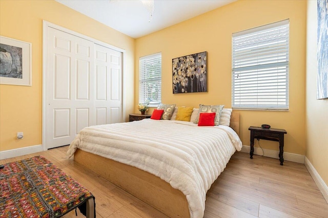 bedroom featuring a closet and light wood-type flooring