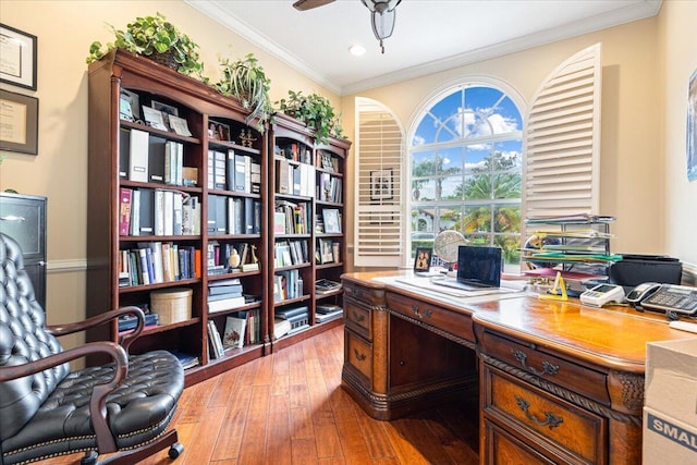 office space featuring ceiling fan, light wood-type flooring, and crown molding