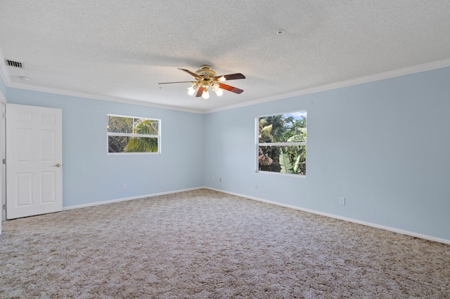 carpeted spare room with ceiling fan, ornamental molding, and a textured ceiling