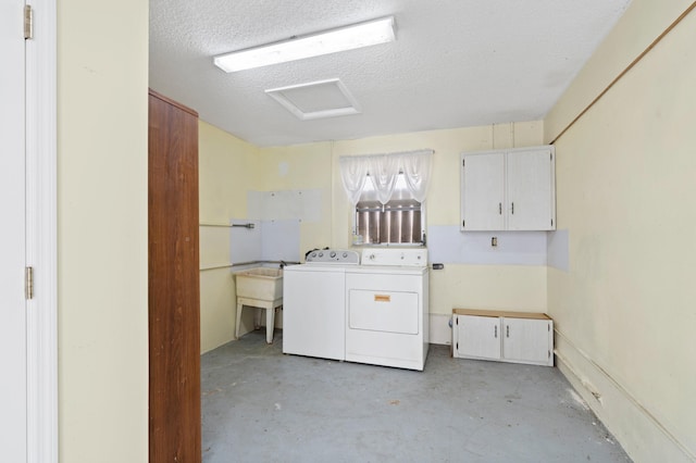 washroom featuring cabinets, independent washer and dryer, and a textured ceiling