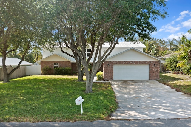 view of front of property with a garage and a front lawn