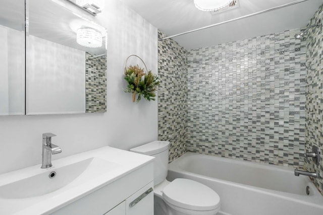 full bathroom featuring toilet, tiled shower / bath, and vanity