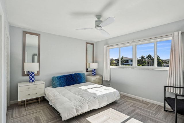 bedroom with ceiling fan and light parquet flooring