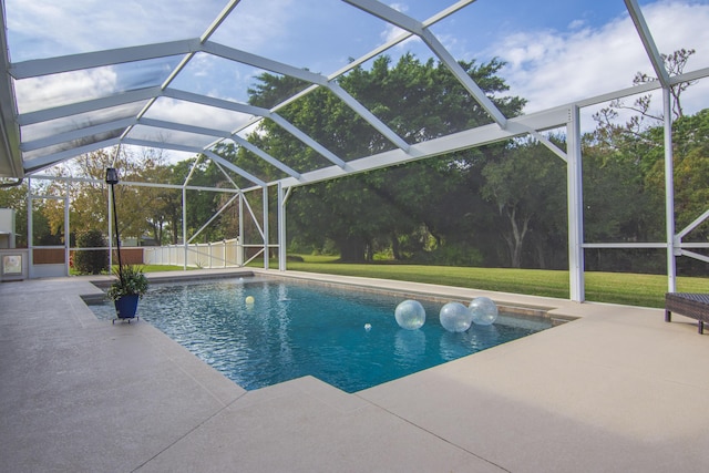 view of swimming pool with a lanai, a patio area, and a lawn