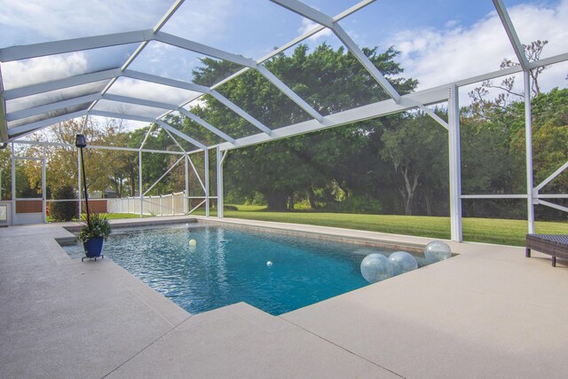 view of pool featuring a yard, a patio, and glass enclosure