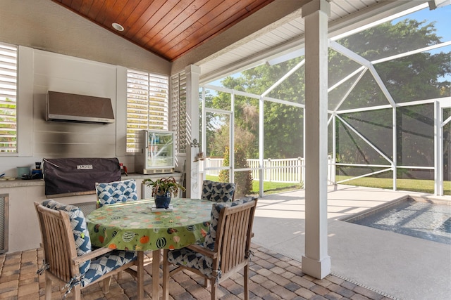 view of patio / terrace featuring a grill and glass enclosure