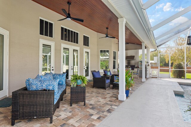 living room with ceiling fan, french doors, dark hardwood / wood-style flooring, a fireplace, and ornamental molding