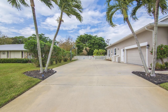 view of side of home with a garage and a yard