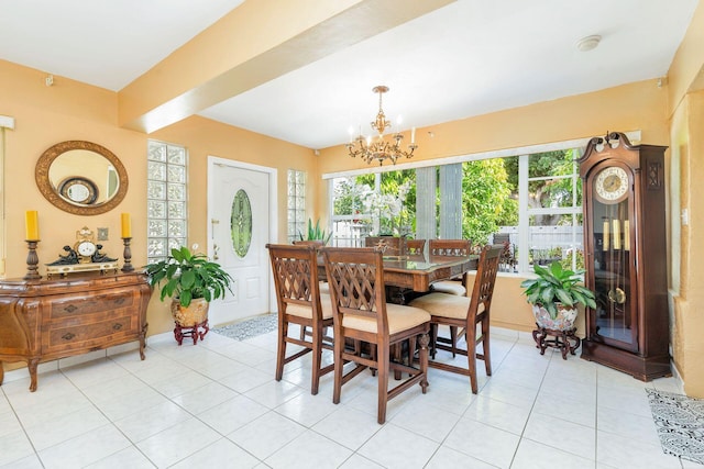 dining area featuring light tile patterned floors and an inviting chandelier