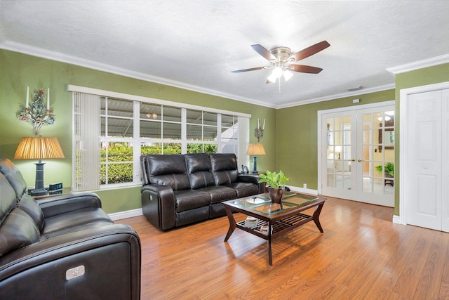 living room with french doors, a textured ceiling, ceiling fan, crown molding, and light hardwood / wood-style flooring