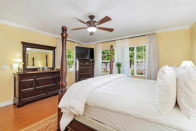 bedroom featuring ceiling fan, crown molding, and light hardwood / wood-style floors