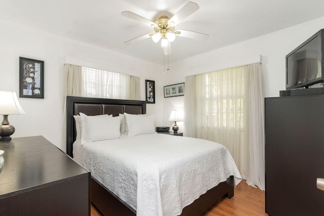 bedroom with ceiling fan and wood-type flooring