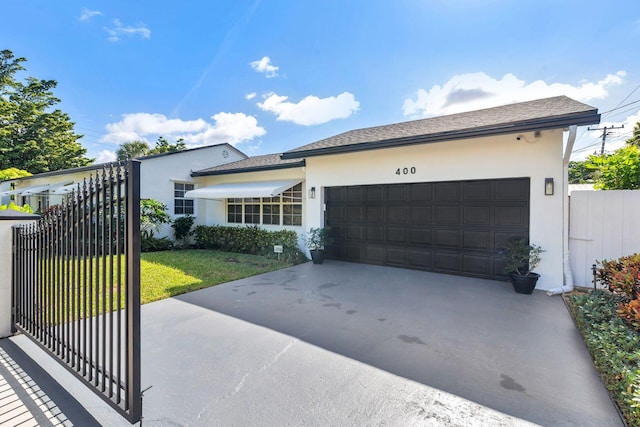 view of front of property featuring a garage and a front lawn