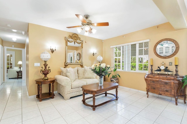 living room with ceiling fan and light tile patterned floors