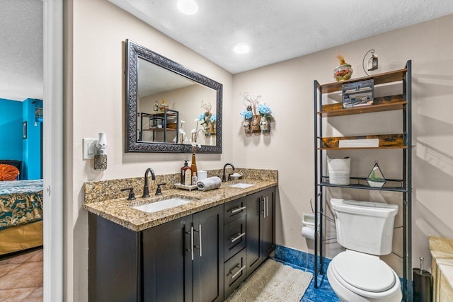 bathroom with vanity, a textured ceiling, and toilet