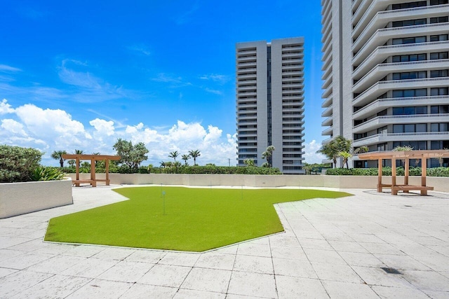 view of property's community with a pergola and a patio