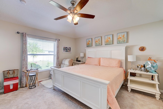 bedroom featuring ceiling fan and light carpet